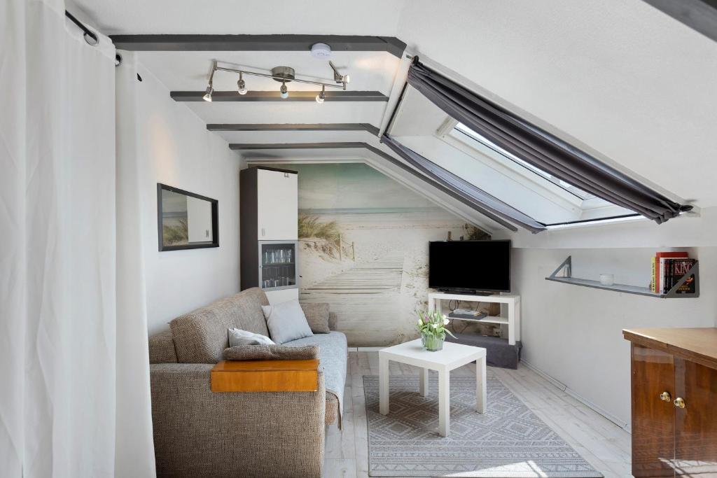 a living room with a couch and a tv at Fewo Kurt in Villingen-Schweninngen in Villingen-Schwenningen