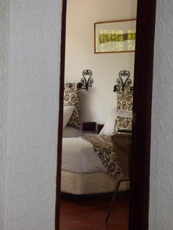 Postel nebo postele na pokoji v ubytování Hostal Mizare Valledupar