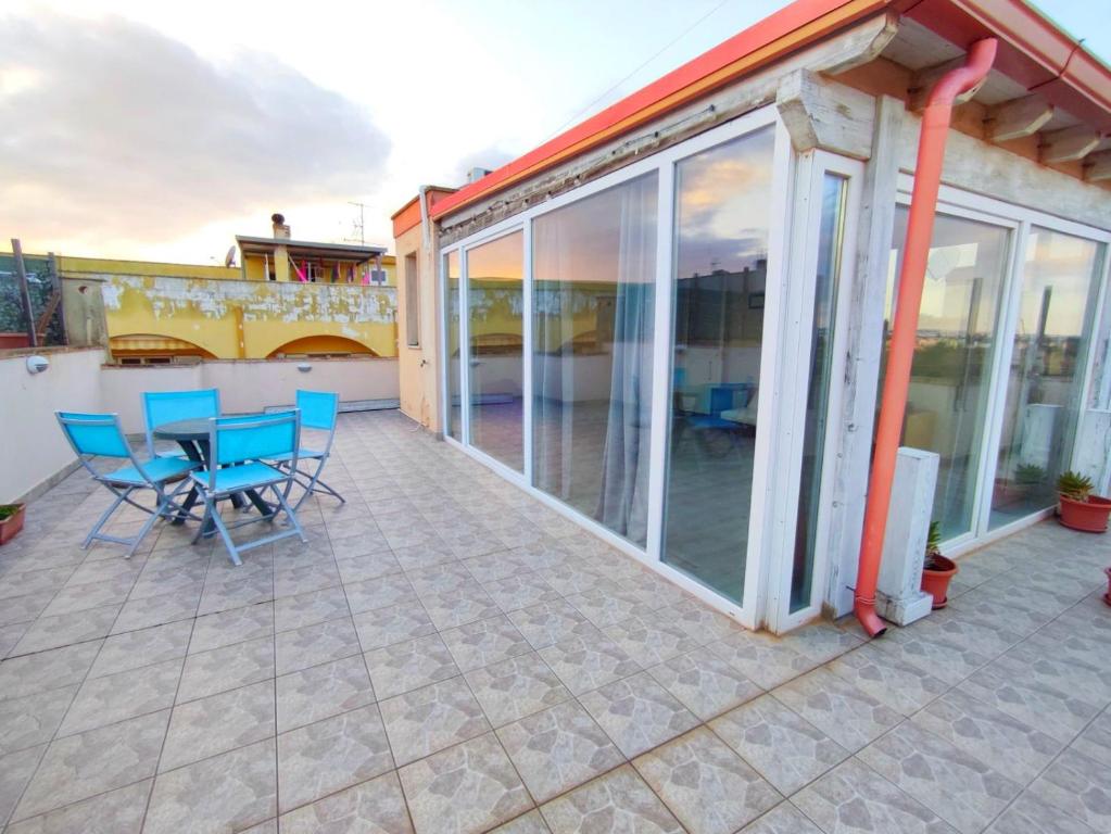 a patio with a table and chairs on it at Terrazza Lumière in Alezio