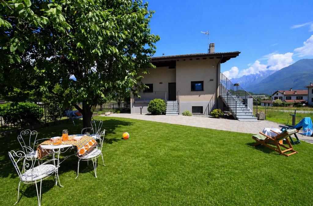 a table and chairs in the yard of a house at Casa Didi & Rosi - Lake Como in Colico