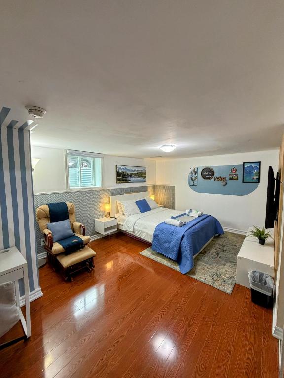 a bedroom with a king sized bed and a chair at Spacious room near subway & shops in Toronto