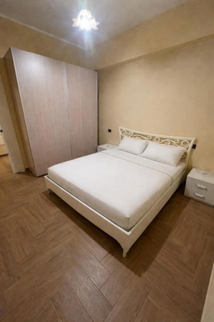 a bedroom with a white bed in a room at Il fico in Bovalino Marina