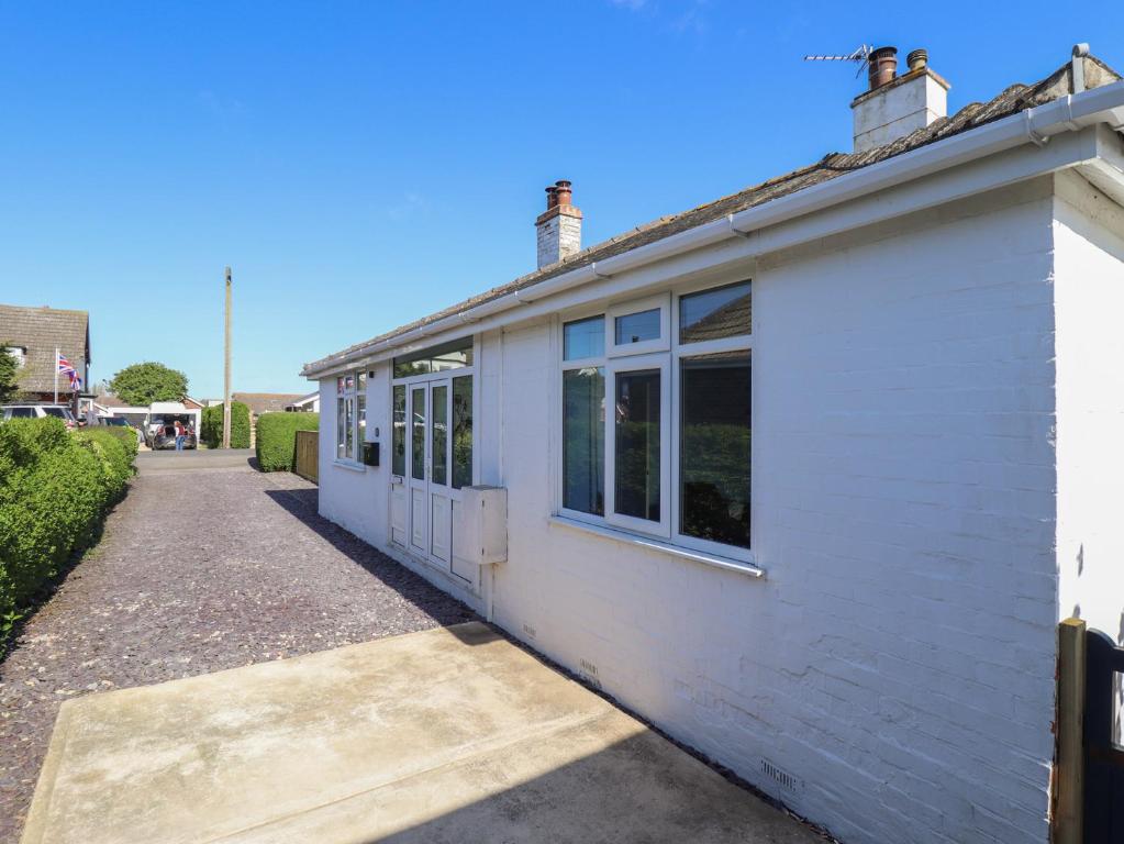 a white building with windows on the side of it at Sorrento in Mablethorpe