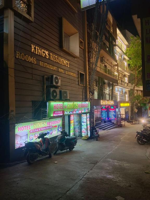 a motorcycle parked in front of a building at night at Hotel King's Residency in Narendranagar