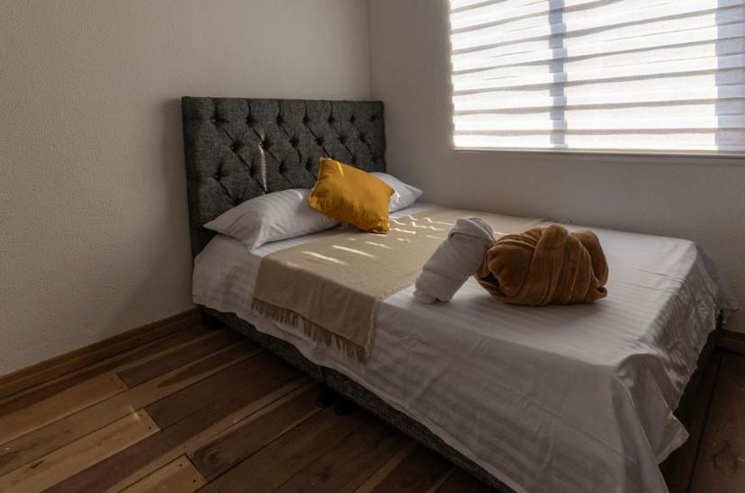 a bed with two pillows on it in a bedroom at El cantor Finca hotel in Quimbaya