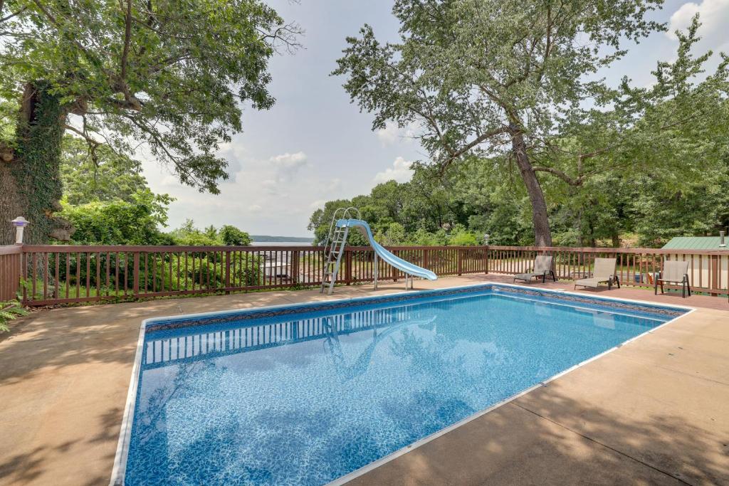 a swimming pool with a slide in a yard at Hot Tub, Pool, Dock: 2 Cabins Lakeview Grand Lake in Grove