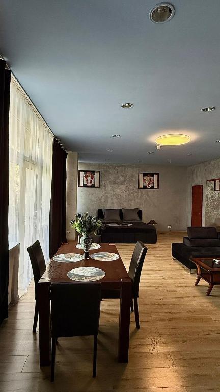 a living room with a table and a couch at Black Pearl Jacuzzi Apartament in Sopot