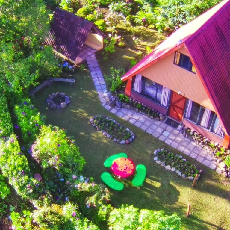 an aerial view of a house with a yard at Reserva Natural Cerro Alto in Empalme