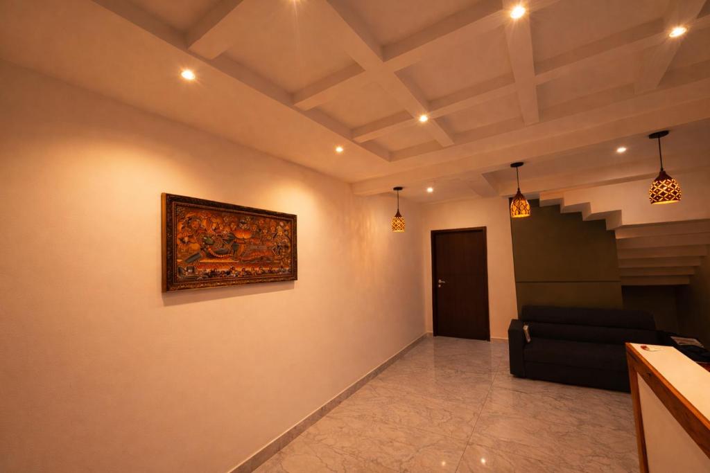 a living room with a painting on the wall at Mahadeva Residency in Trivandrum