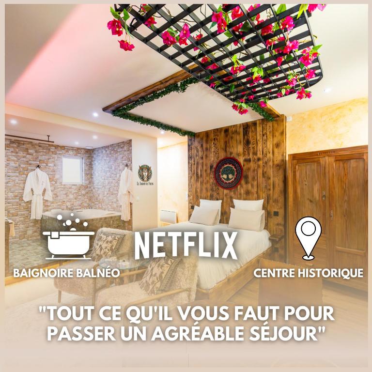 a hotel room with a bed and a sign that says hotel ce oil yours fault at Le Jardin de Freya - Balnéo - Centre historique in Auch