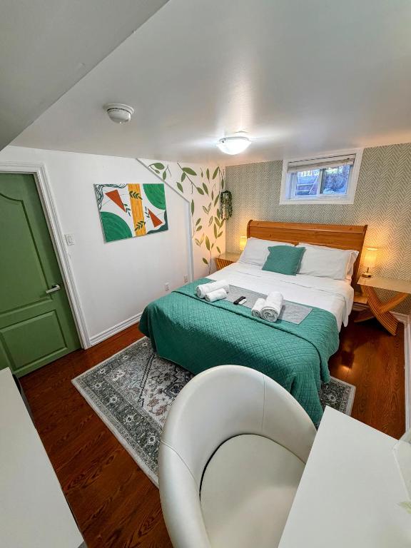 a bedroom with a bed and a chair in it at Private room near subway & shops in Toronto