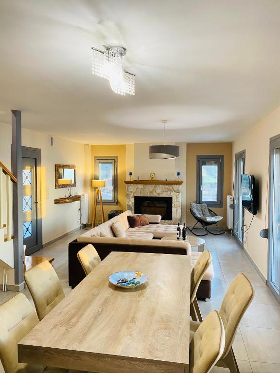 a living room with a table and a couch at Athos view house in Agios Ioannis Kaspaka