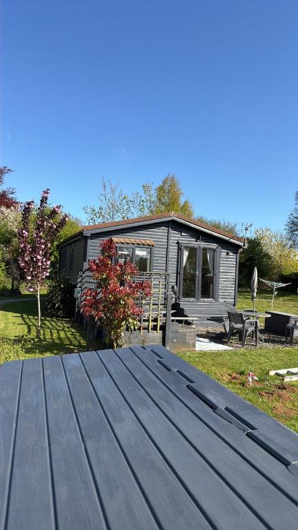 a tiny house with a roof on a yard at The Old Inn Retreat in Spilsby