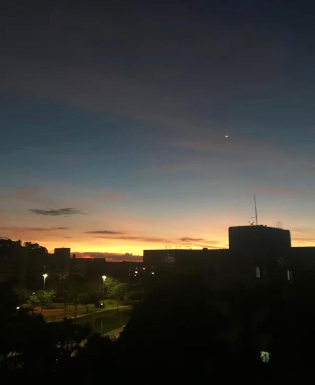a view of a city at sunset at Quarto Sol in Brasília