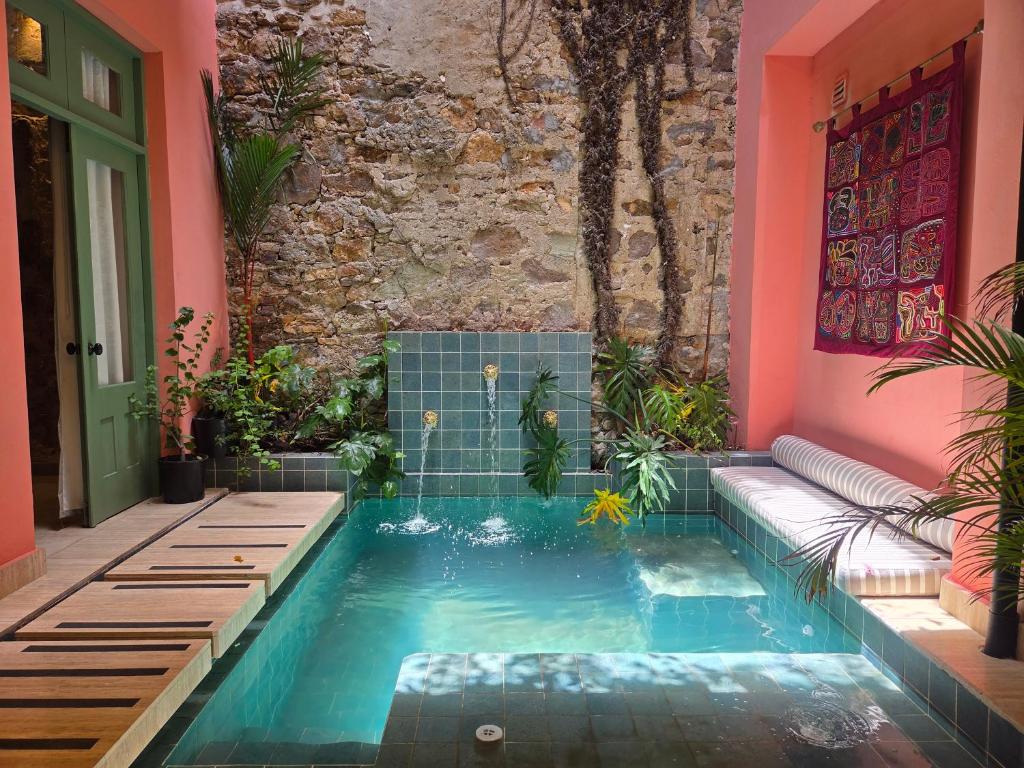 a swimming pool in the middle of a house at Casa AcoModo at Casco Viejo 6BR Mansion w Pool in Panama City
