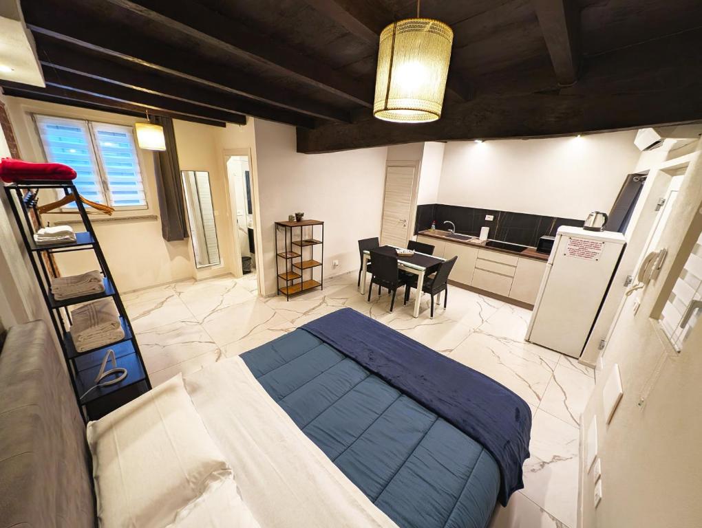 a bedroom with a bed and a kitchen with a table at Le torri Virgo in Fossano