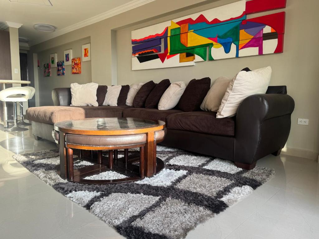 a living room with a couch and a coffee table at Apartamento Costa Azul Oasis frente CC La Vela in Porlamar