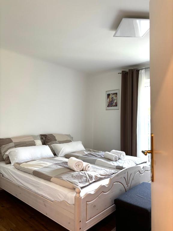 a bedroom with a bed with white sheets and pillows at Wien an Donau in Vienna