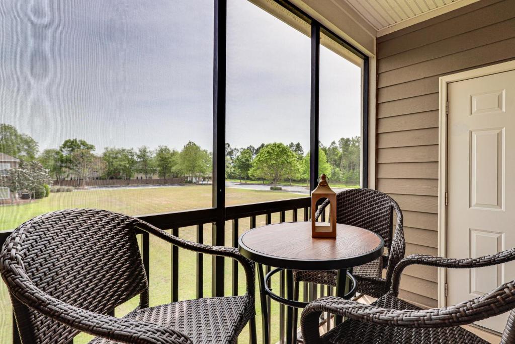 a porch with two chairs and a table and a window at Pool Access! Recently Updated Coastal Retreat in Foley