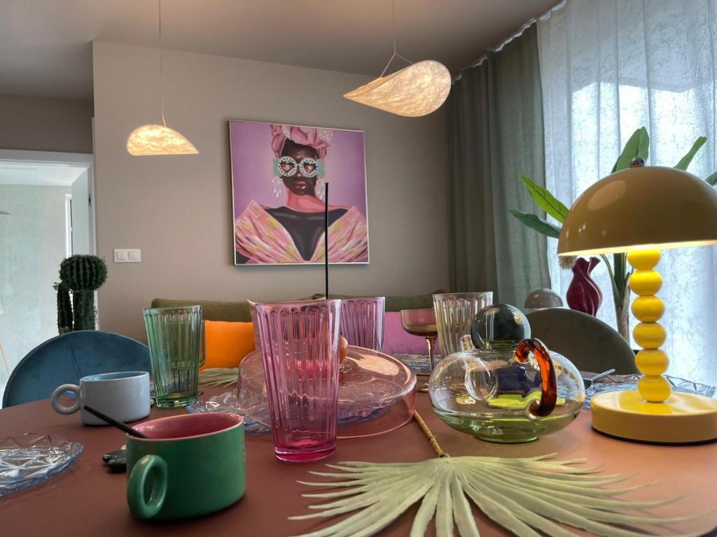 a dining room table with glasses on top of it at Sunday Apartamenty SPA Miraż in Ustronie Morskie
