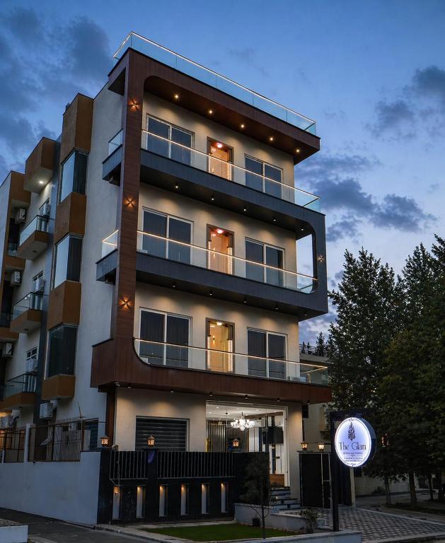 a tall building with lights on the side of it at The Glam By Sandane Homes in Greater Noida
