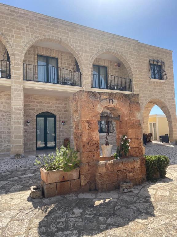 a stone building with two balconies on top of it at Villa Arneide bed and breakfast in Torre Lapillo