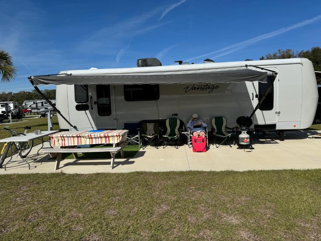 a person sitting in front of a trailer at The Boardwalk in Westfield Beach