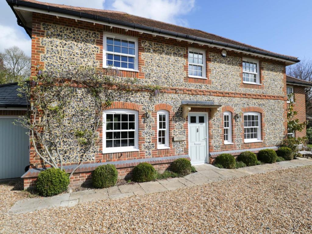 a brick house with a white door at Ormiston House in Pewsey