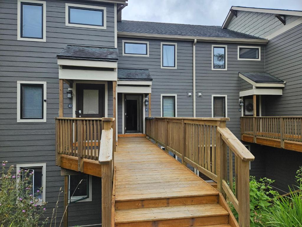 a house with a wooden deck in front of it at Powderidge 42 2 Br: Sleeps 10 in Snowshoe