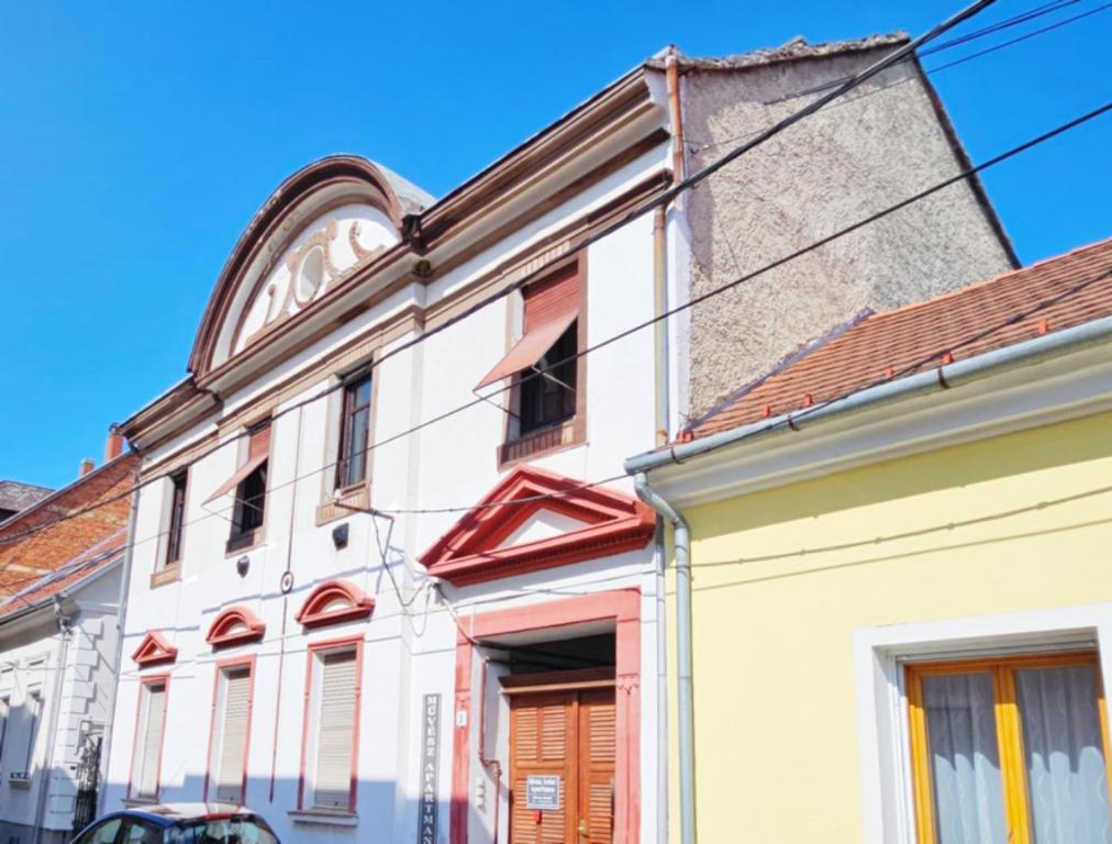 an old white building with a red roof at Artist Apartment in Keszthely