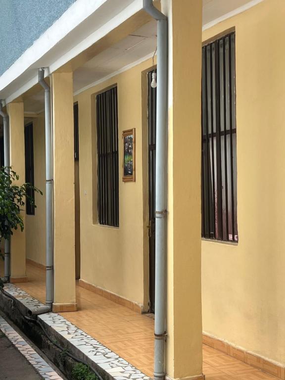 a hallway of a house with columns and windows at Zebra guesthouse Hawassa in Āwasa