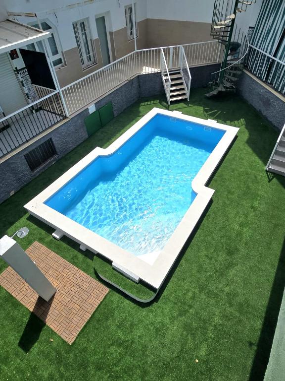 an overhead view of a swimming pool in a yard at PISO CENTRICO EN PUNTA UMBRIA in Punta Umbría