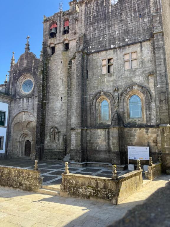 an old stone building with a clock tower at Cabalo Holiday Inn in Tui