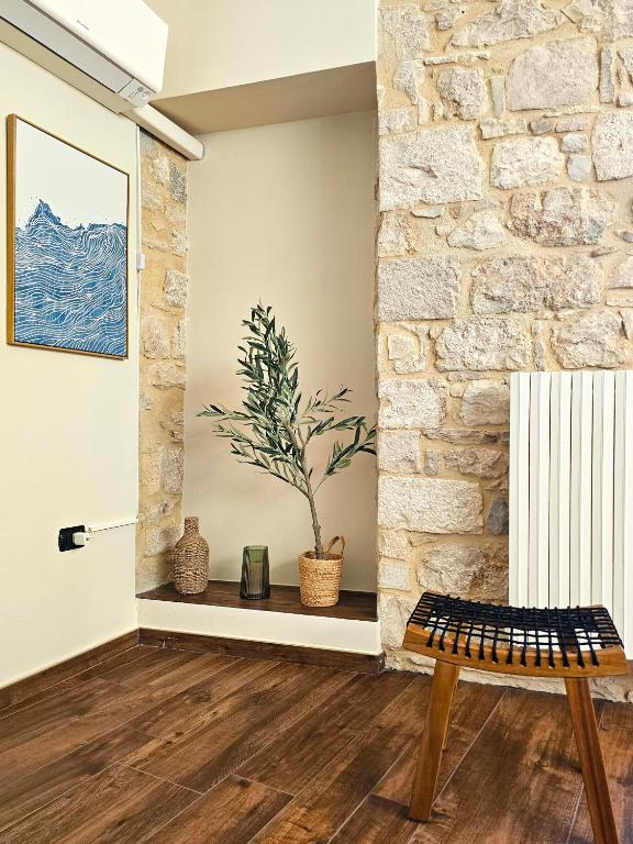a living room with a bench and a stone wall at Maestrale in Giovinazzo