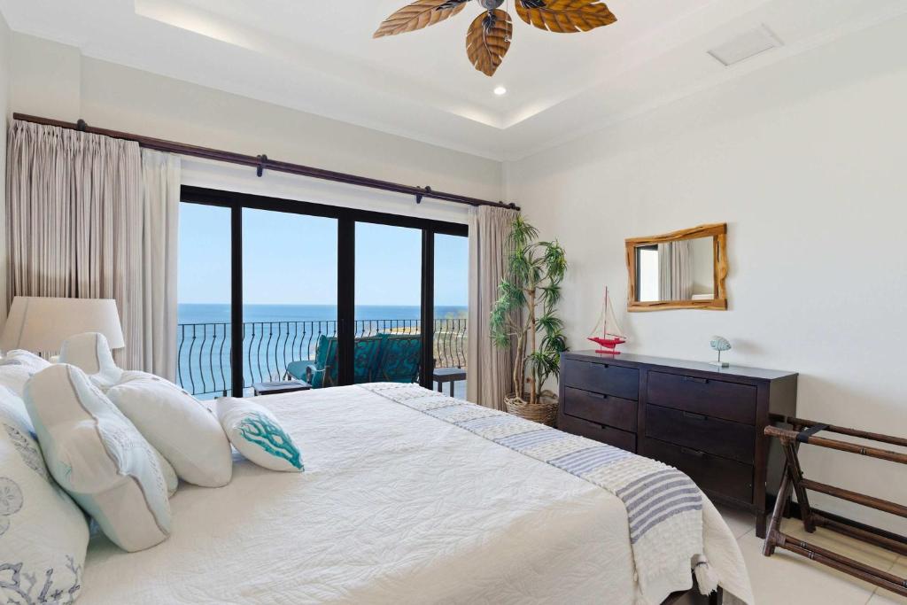 a bedroom with a bed with a view of the ocean at Wake Up to the Pacific, Concierge Included in Playa Flamingo
