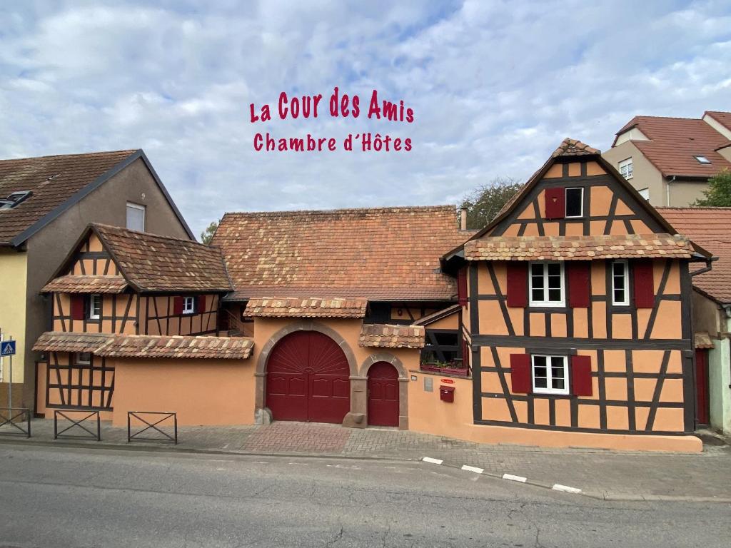 a building with a sign that reads is not its ans change its tires at La Cour Des Amis in Vendenheim