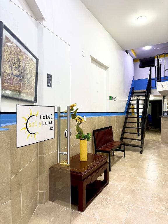 a lobby with a bench and stairs in a building at Hotel Sol y Luna 2 in Medellín