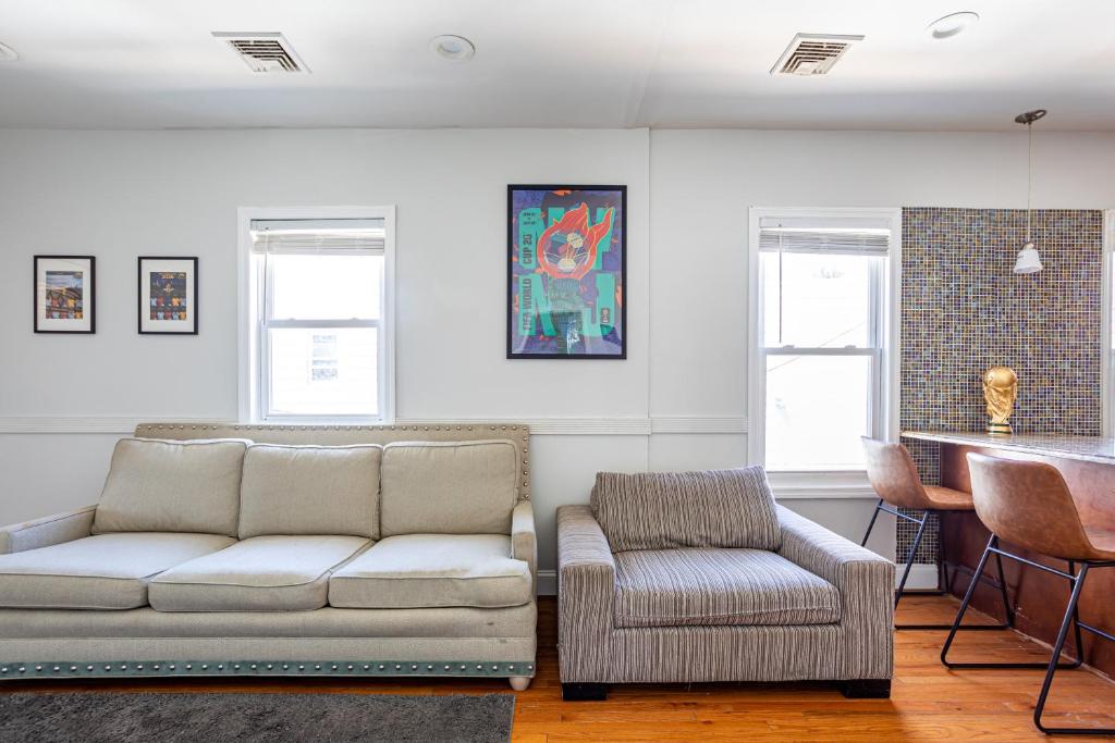 a living room with a couch and a chair at Spacious 2BR-1BA-4 Beds NYC MetLife Parking in Bayonne