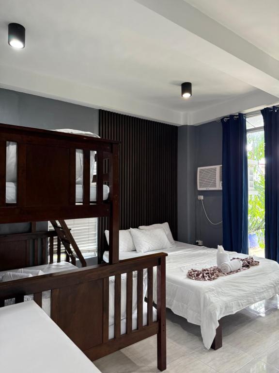 a bedroom with two beds and a bunk bed at Dajon#4-Barkada Generator & starlink in General Luna