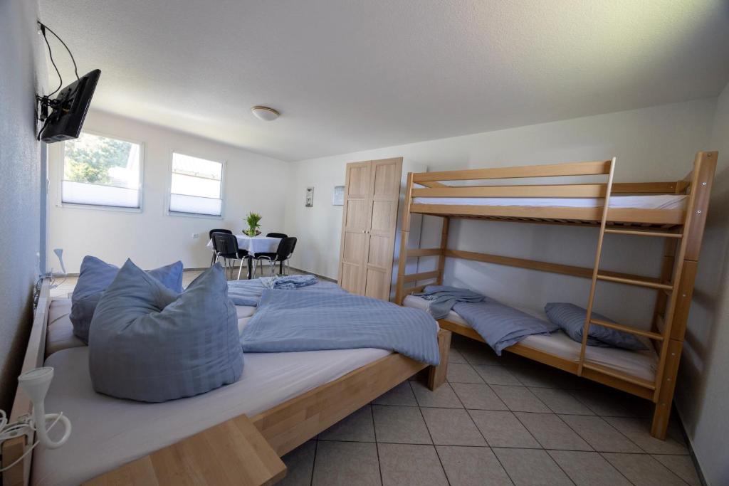 a bedroom with two bunk beds and a table at Ferienpark Buntspecht Apartment A in Pruchten
