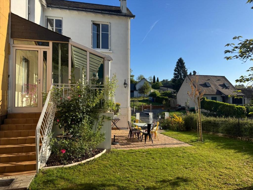 a house with a garden and a patio at Gite La Forge in Rochecorbon