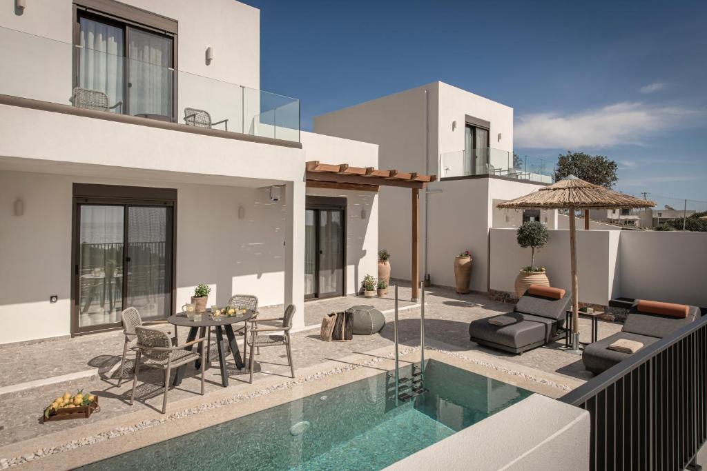 a villa with a swimming pool and a house at Abas Villas in Paránimfoi