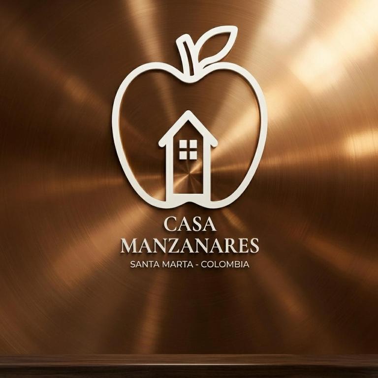 an apple logo with a house in the middle at Hotel Casa Manzanares in Santa Marta