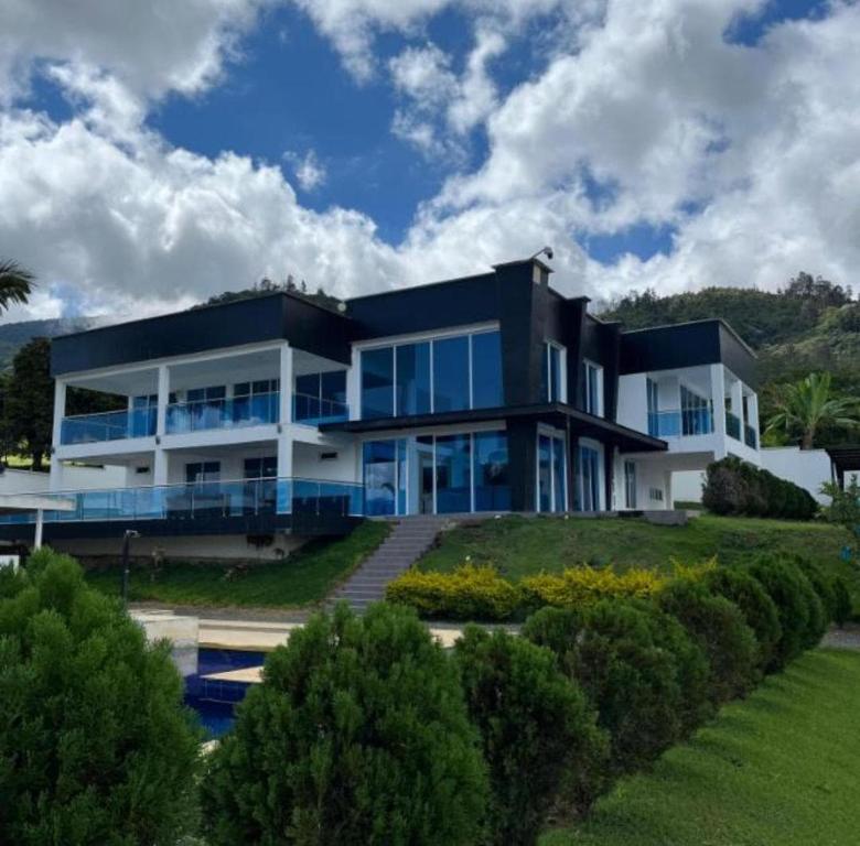 a large black house with a lot of windows at Finca Villa Sonada in Darién