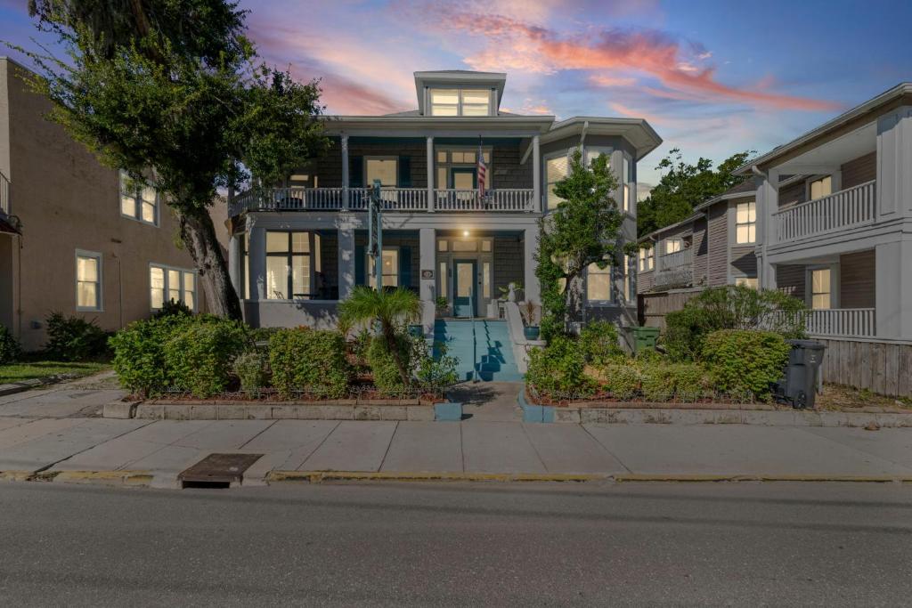 a large house with a porch on a street at Southern Wind Inn in St. Augustine