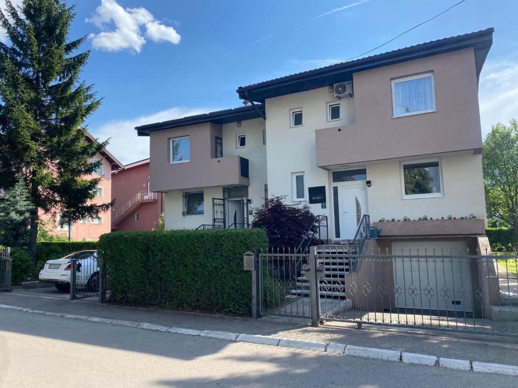 a house with a fence in front of it at Holiday Home Ilidza Rose in Sarajevo