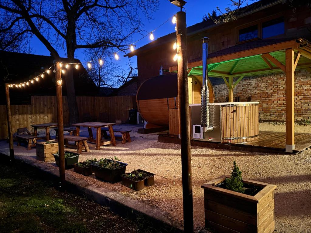 a backyard with a picnic table and a gazebo with lights at KLOBUCKÉ RETRO bydlení a wellness in Valašské Klobouky