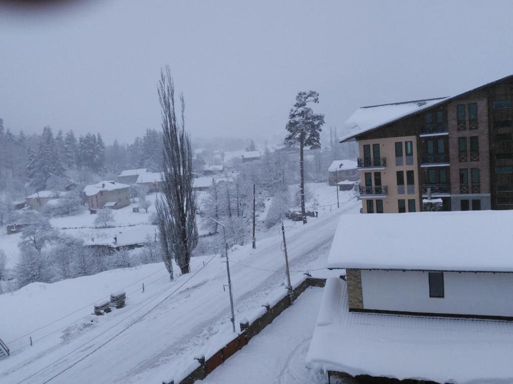 a view of a snow covered city with buildings at Apartment Bobline in Bakuriani