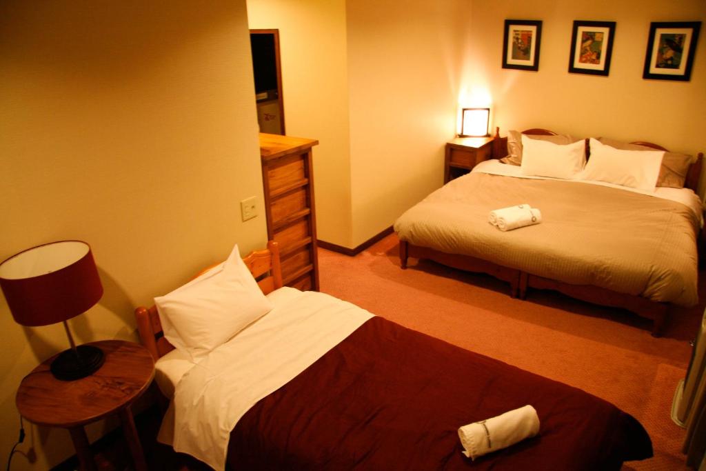 Postel nebo postele na pokoji v ubytování Morino Lodge - Hakuba