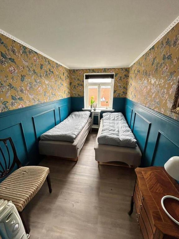 a room with three beds and a window at AE325-Marstal-Skovgyden-32 in Marstal